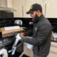 Kitchen-Technician-Inspecting-Taped-Pipe-Component