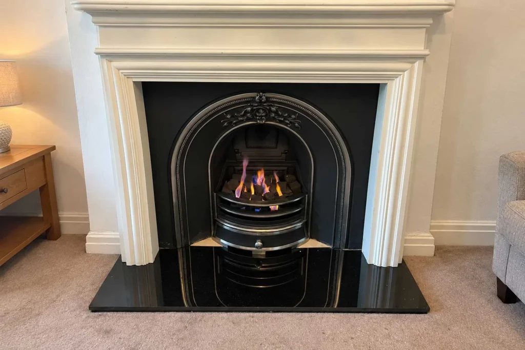 Traditional gas fire installed in a decorative fireplace