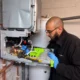 Focused Technician Repairing Boiler